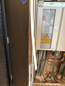 Fire-Rated Construction Materials: Ensuring Safety and Compliance in Building Design - image displays a broken fire door, improperly installed.